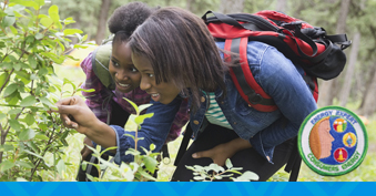 girl scouts looking at plants